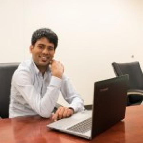 Devendra Khatiwada seated at a desk